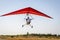 Motorized hang glider soaring in the blue sky