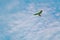 Motorized hang-gliding against blue sky with white clouds. Copy space.