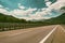 Motorway road in Alps, beautiful day time landscape with blue cloudy sky