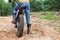 Mototrial rider standing on motorcycle in sand. Extreme sports on motorcross motorcycles. Copy space