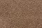 Mottled brown textile texture. Can be used as background.