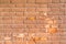 A mottled red brick wall