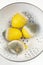 Moulded lemons in strainer on white background