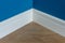 Moulding in the corner. Blue Matte Wall with laminate immitating oak texture