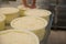 Moulds with pressed curd on table at cheese factory