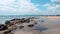 Mound of large stones on the beach. Cobblestones on the sandy shore of the Black Sea in the Crimea.