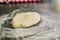 Mound of wheat flour on top of black granite table, preparation of pizza dough