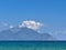 Mount Athos on a sunny day, shrouded in clouds. View from Sarti, Greece
