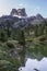 Mount Averau reflected in lake Limedes at sunrise, blue sky with clouds, Dolomites, Veneto, Italy