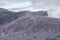 Mount Bromo with a puff of smoke from its caldera. The Bromo Tengger Semeru area is a popular tourist destination in Indonesia.