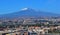Mount Etna towers over Catania, Sicily, Italy