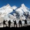 Mount Everest with black silhouette of five climbers