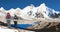 mount Everest and Nuptse from Nepal side as seen from Kala Patthar peak and two tourists with big backpacks