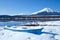 Mount Fuji with boat at Iced Yamanaka Lake in Winter