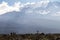 Mount Kilimanjaro with native porters carrying pack on their heads