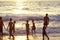 Mount Lavinia Beach. Colombo, Sri Lanka. 05th March 2016. Silhouette of  group of boys  at the beach with the sunset background