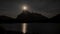 Mount Rundle with moonrise in summer night. View from Vermilion Lakes lakeshore