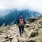 Mount Rysy Tatras Slovakia Woman traveler backpack tracking sticks top mountain