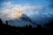 Mount Sass de Stria at sunrise, blue sky with clouds and fog, Falzarego pass, Dolomites, Veneto, Italy
