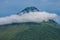 Mount Scenery covered in forests and clouds under a blue sky in the Caribbean Netherlands