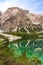 Mount Seekofel mirroring in the clear calm water of iconic natural mountain lake Pragser Wildsee