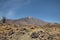 Mount Teide surrounded by the rocky volcanic and unusual landscape with Roque Cinchado on the left