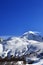 Mount Tetnuldi and off-piste slope with track from ski and snowboard in sun day