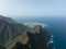 Mountain aerial of cliffs, high mountains, along the Atlantic coast line. Panoramic beautiful rough sea green rocky