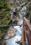 Mountain alpine autumn Wimbachklamm gorge and Wimbach stream with wooden path, Berchtesgaden national park, Alps, Bavaria, Germany