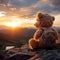 Mountain backdrop, teddy bear toy sits peacefully, sunset serenity captured