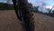 Mountain bike front wheel point of view riding a rocky trail