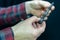 mountain bike repair. Bike mechanic in the workshop. Mechanic holds the axle in his hand from the back of the bike bushing. Hand