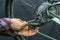 Mountain bike repair in the workshop. Mechanic\'s hand and rear derailleur close-up. Gearshift settings