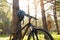 Mountain Bike on Summer Trail in the Beautiful Pine Forest Lit by the Sun. Adventure and Cycling Concept.