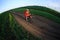 Mountain bikeer rides on the trail against beautiful sunset