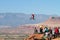 Mountain biker jumps cliff and crowd watches