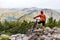 Mountain biker looking at view on bike trail in autumn mountains