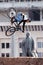 Mountain biker makes a stunt in front of Lenin monument