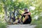 mountain biker resting in forest, sitting on ground