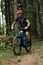 Mountain biker riding on bike in autumn inspirational mountains landscape banner. Man cycling MTB on enduro trail track. Sport