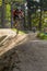 Mountain biker speeding downhill on a mountain bike track in the woods