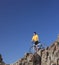 Mountain biker standing on a rocky cliff