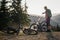 Mountain biker washing the mountain bikes in the sunset after a day of riding