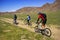 Mountain bikers on old road in steppe