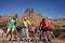 Mountain bikers are posing to the camera in front of Omalo tower