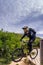 A mountain bikers wearing safety gears jumping downhill, Etretat, France