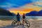 Mountain biking, couple with bikes at sunset on Lake Garda, Riva del Garda, Italy