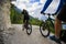 Mountain biking couple with bikes on track, Cortina d`Ampezzo, D