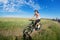 Mountain biking happy sportive girl relax in meadows sunny countryside