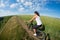 Mountain biking happy sportive girl relax in meadows sunny countryside